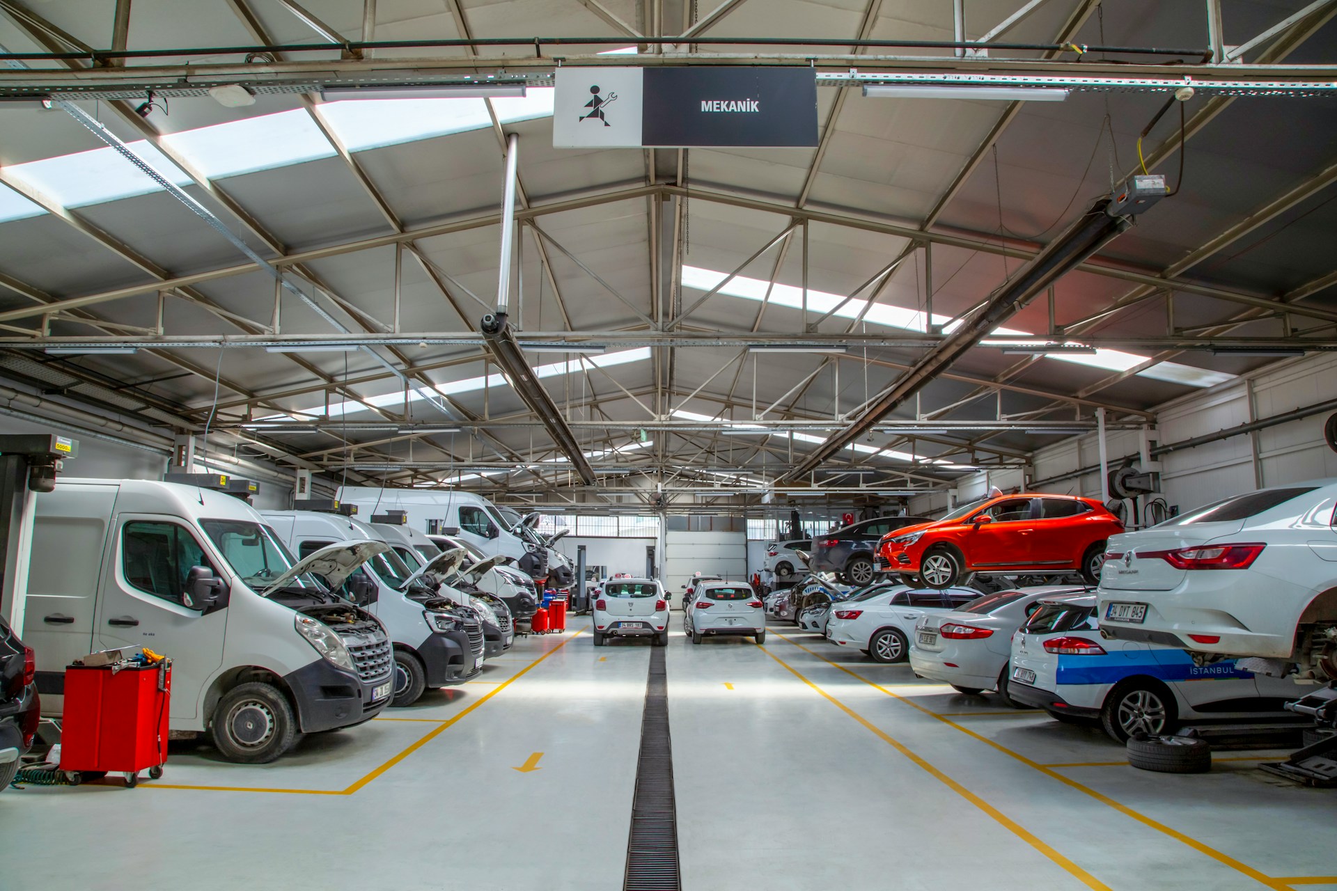 mehmet-talha-onuk-5M-72czGFl4-unsplash A warehouse filled with lots of cars and trucks